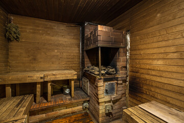 Fototapeta na wymiar standard design classic wooden russian bath sauna interior with hot stones