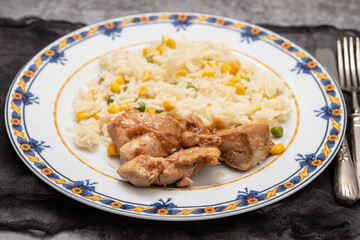 chicken fillet baked with sauce and boiled rice with vegetables