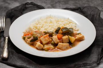 squid stew with vegetables and boiled rice on plate