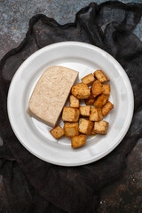 crispy deep stir fried tofu cubes on small dish
