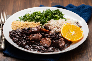 black beans stew with sausages on a white dish