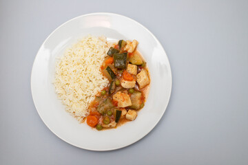 squid stew with vegetables and boiled rice on plate