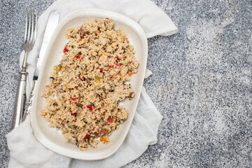 Couscous with vegetables in a dish with fork