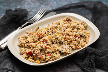 Couscous with vegetables in a dish with fork