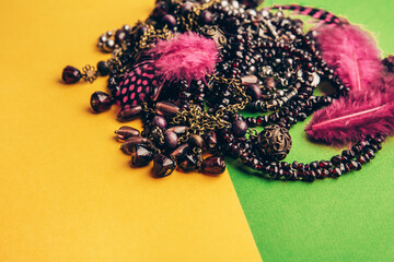 Colorful group of Mardi Gras. Mardi gras carnival decoration beads, yellow green background.