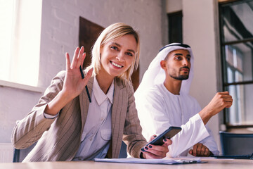 Multiracial group of corporate businesspeople working in a business office - Multiethnic businessmen and businesswomen meeting in the office in Dubai, UAE