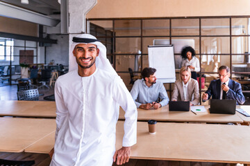 Multiethnic business team meeting in the office, portrait of arab businessman wearing traditional...