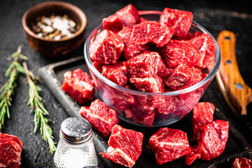 Raw beef tenderloin in a glass bowl with spices.  - 564203620