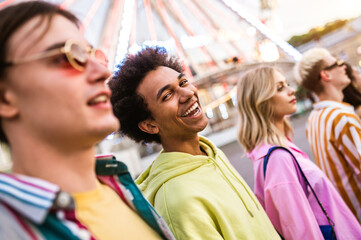 Multiracial young people together meeting and social gathering - Group of friends with mixed races having fun outdoors in the city- Friendship and lifestyle concepts