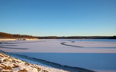 Scenic View Of Frozen Landscape Against Blue Sky