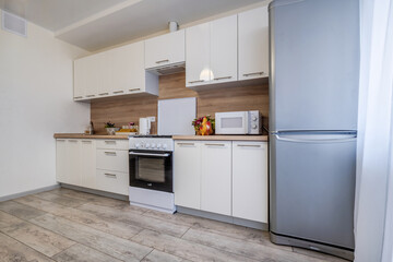 Fototapeta premium Interior of the modern luxure kitchen in studio apartments in minimalistic style