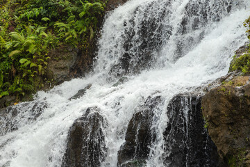 Uma Anyar waterfall, Bali, Indonesia. Jungle, forest, daytime with cloudy sky.