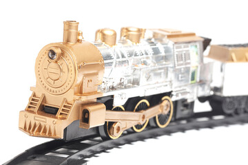 toy train with freight car trolley on railway tracks, isolated on white background, children's railway with steam locomotives, battery powered train.
