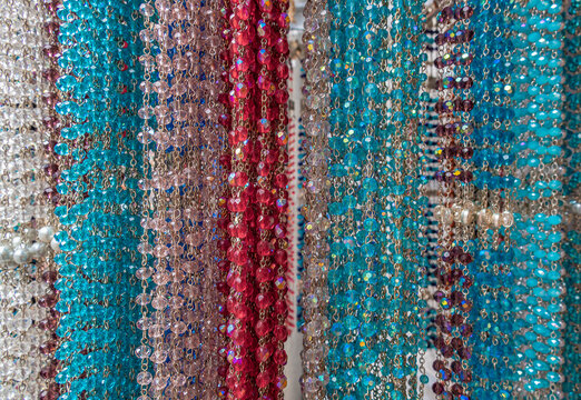 Colorful rosaries in a souvenir and devotional shop in Lourdes, France