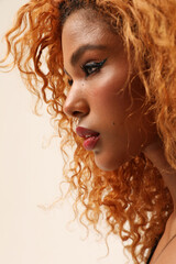 Fototapeta premium Young beautiful woman with afro hair posing indoor. Mindset and mental health.