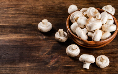 A wooden plate full of fresh mushrooms. 