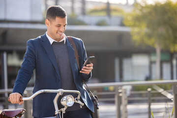Bike, travel or business man with phone for networking, social media or communication in London...