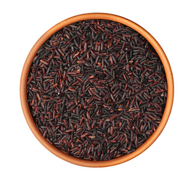 Wild black rice in clay pot isolated on white background, top view