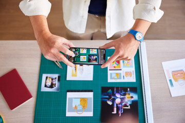 Faceless man taking pictures of photos in workspace