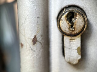 Selective focus view of rusty keyhole made from iron metal with blurred background. Macro photography.