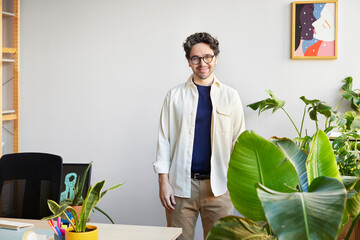 Smiling man standing in home office
