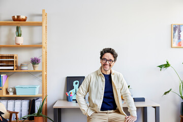 Smiling freelancer sitting in creative studio