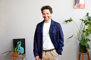 Happy male with hand in pocket