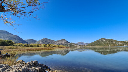Panoramic view from the lakeshore of Lake Skadar National Park in autumn seen from Godinje, Bar, Montenegro, Balkans, Europe. Stunning travel destination in Dinaric Alps near Albanian border. Hiking