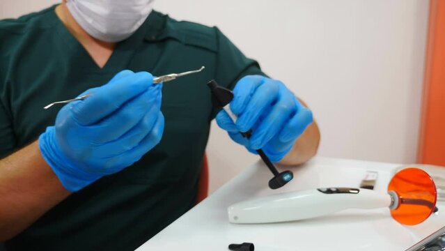 Dentist mixes filling mixture taking material out of tube. prepared solution for dental treatment. Part of curing process in modern clinic. Dentist mixing dental cement. fluoride for fluoridation. 4 k