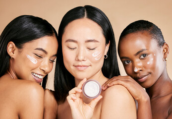 Diversity, face and cream product by women in studio for skincare, wellness and grooming on brown...