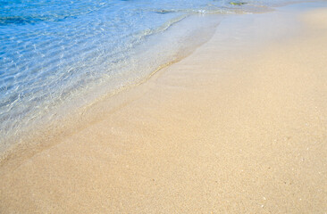 Blue sea and empty beach or coastline (no people, plants, animals).
beautiful nature background Waves and golden yellow sand.