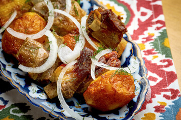 Shashlik or shish kebab from different types of meat served on a plate. Traditional grilled meat for Eastern cultures. Barbecue