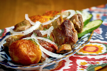 Shashlik or shish kebab from different types of meat served on a plate. Traditional grilled meat for Eastern cultures. Barbecue