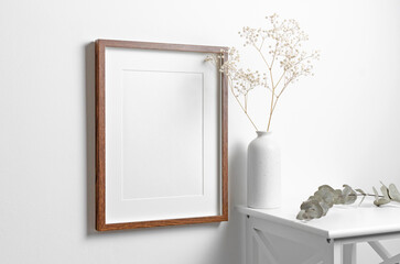 Blank portrait frame mockup on white wall with copy space for artwork, photo, painting or print presentation