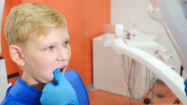 Young male patient having hid bad tooth x-rayed. Dental equipment. Dentistry and healthcare. Photo of teeth at professional dentistry. Process of getting X ray image. 4 k video