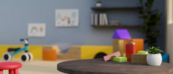 Copy space on table with kid toys over blurred background of colorful kids playroom or classroom.