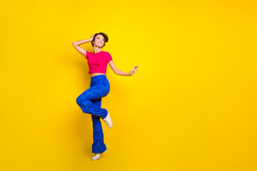 Fototapeta na wymiar Full length photo of positive glad lady wear pink trendy clothes celebrate holiday event empty space isolated on yellow color background