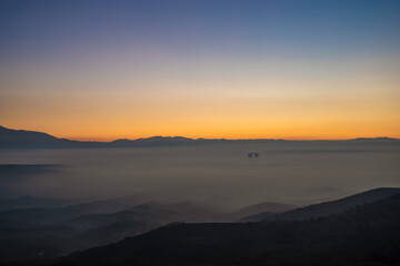 Colorful sunset shot in the mountains above the clouds on a winter day