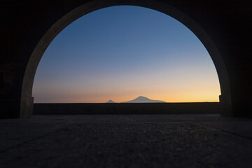 View of mount Ararat from Charents arch, at sunset with colorful sky - obrazy, fototapety, plakaty