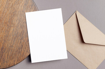 Blank invitation or greeting card mockup with envelope on grey paper background