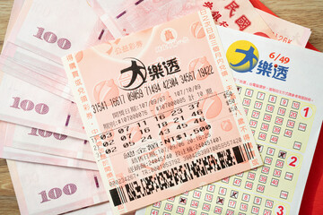 Taipei, Taiwan - 21 Jan 2023: Closeup of Red envelope packetp,Taiwanese currency and Taiwan lottery tickets: Big Lotto.