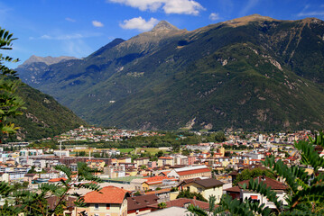Fototapeta na wymiar Landscape with a view of the mountains, the town of Bellinzona at their feet, against the blue sky with clouds, in Bellinzona, near Locarno, in southern Switzerland