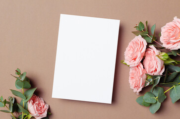 Invitation card mockup with fresh pink roses and eucalyptus flowers