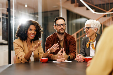 Smiling business people having a meeting at the office, making some plans.
