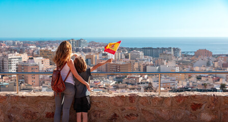 Family in Spain- mother and children with spanish flag - obrazy, fototapety, plakaty