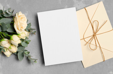 Wedding invitation card mockup with envelope and fresh roses flowers, card with copy space