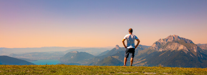 Man looking at panoramic view of sunset mountain