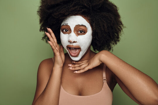 Black woman with cream face mask