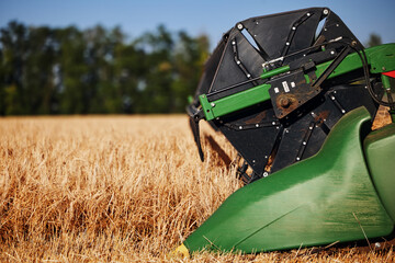 Agricultural combine harvester in the field during harvest ripe wheat. Combine working on a wheat...