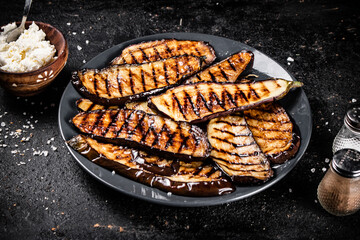 Slices of eggplant grilled in a plate. 